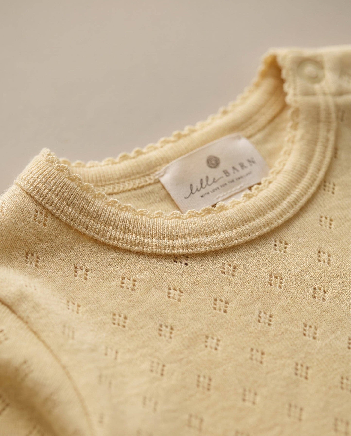 Woolen romper, long sleeves, pointelle - merino wool - Dusty Yellow: 56