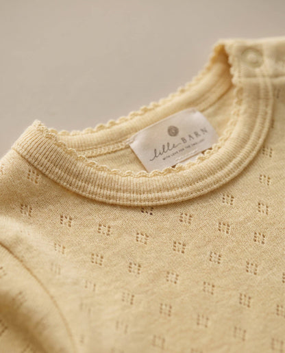 Woolen romper, long sleeves, pointelle - merino wool - Dusty Yellow: 56