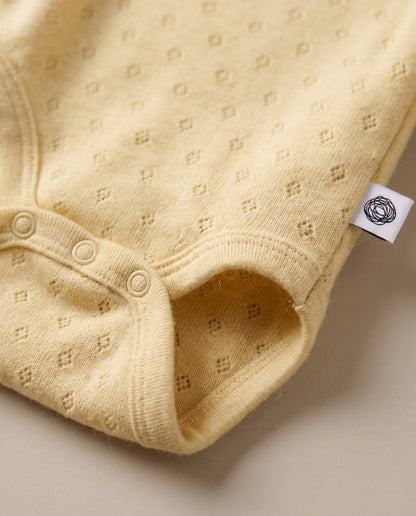 Woolen romper, long sleeves, pointelle - merino wool - Dusty Yellow: 68