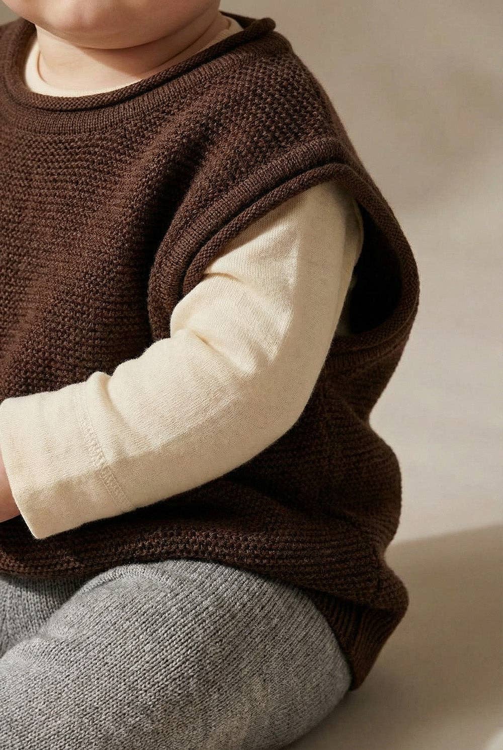 MERINO WOOL KNITTED BABY VEST
- CAROB: 50/56